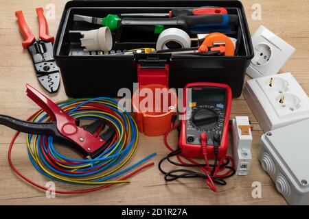 Tools for electrician needs: shocket multimeter, voltage testers, wire strippers, pliers, Stock Photo