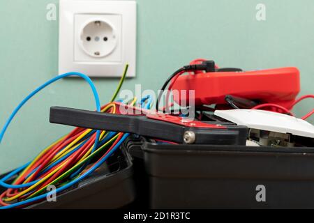 Tools for electrician needs: multimeter, voltage testers, wire strippers, pliers, Stock Photo