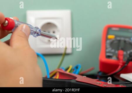 Tools for electrician needs: multimeter, voltage testers, wire strippers, pliers, Stock Photo