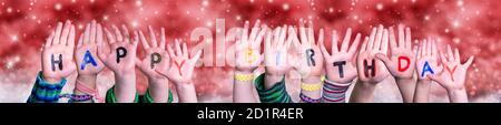 Children Hands Building Word Happy Birthday, Red Christmas Background Stock Photo