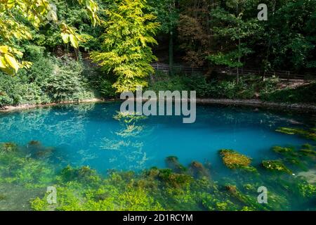 The blue shining lake Blautopf in Blaubeuren Stock Photo
