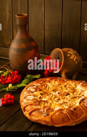 Apple and rowan pie on dark wooden table Stock Photo