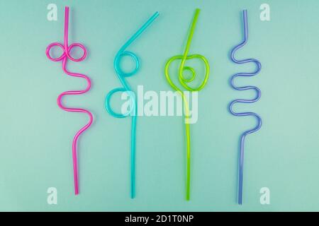 multicolored plastic cocktails straws on blue background. Stock Photo