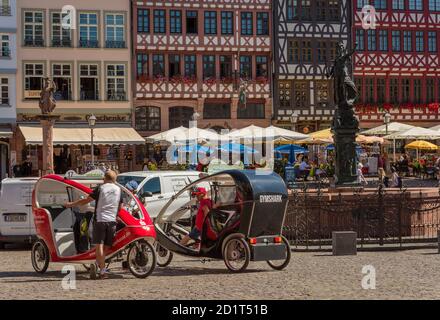 Rickshaw drivers with their vehicles on the Roemerberg waiting for passengers for a city tour, Frankfurt, Germany Stock Photo