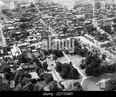 BURY ST EDMUNDS, Suffolk. Aerial view of the town, abbey remains and St Edmundsbury Cathedral. The Cathedral was formerly the Church of St James within the abbey precinct. Adjoining it is the Norman Gate (1120-48) which lead from the town into the abbey interior. Abbeygate, to the right, lead onto the Great Court - the public area in front of the abbey complex. It was rebuilt after 1327 when rioting destroyed the original gate. Photographed in 1920. Aerofilms Collection (see Links). Stock Photo