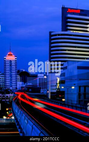 Light trails from Skytrain elevated railway in central Bangkok, Thailand Stock Photo