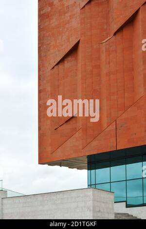 Detail of the wall of a neo constructivism building made of red brick and glass. Stock Photo