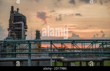 Refinery tower at a petrochemical plant with cloudy sky. After sunset ...