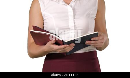Woman hands holding Notebook and turning pages looking at it on Stock Photo