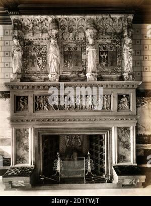 EATON HALL, Eaton, Cheshire. The fireplace and ornate mantlepiece in the saloon at Eaton Hall. Eaton Hall was remodelled in the Gothic style in 1870-1882 by Alfred Waterhouse for the Duke of Westminster. In 1963 the main part of the hall was demolished, and a new hall constructed. The chapel, clock tower and stables were retained. Photographed by Bedford Lemere in 1887. Stock Photo