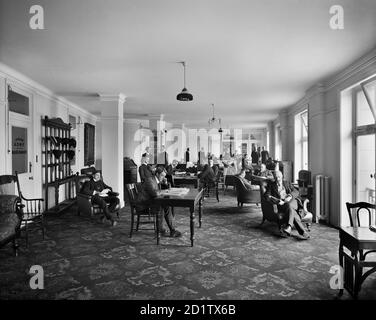 YMCA CENTRAL BUILDING, Exeter Hall, Strand, London. An interior view of the reading room in the YMCA's headquarters. The site of Exeter Hall is now occupied by the Strand Palace Hotel. The YMCA was founded in 1844 to provide Christian fellowship for clerks and shop assistants, but quickly expanded to serve a much wider public. Photographed by Bedford Lemere and Co. in July 1907 for the YMCA. Stock Photo