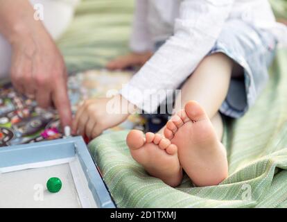 Selective focus of kid playing board game in montessori school Stock Photo