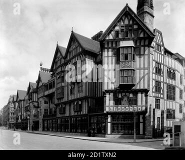 LIBERTY'S, Regent Street, London. Exterior view showing the Great Marlborough Street facade of Liberty's newly completed Arts and Crafts Tudor style department store. This extraordinary building was constructed in 1922-24 using timbers from HMS Hindustan and HMS Impregnable. It was a remarkable reaction to the early twentieth century vogue for stone dressed steel-framed buildings. Designed by Edwin T. Hall and E. Stanley Hall. This photograph was commissioned by Higgs and Hill, builders. Photographed by Bedford Lemere and Co. in 1924. Stock Photo