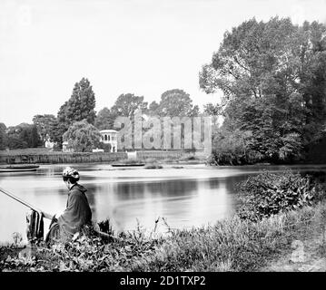 NAZARETH HOUSE, Isleworth, Hounslow, London. The buildings of the convent of the Sisters of Nazareth, rebuilt on the site of Isleworth House by Edward Blore in 1832, taken from across the river Thames. A young lady is waiting for the Rails Head ferry boat in the foreground. Photographed by Henry Taunt between 1860 - 1922. Stock Photo