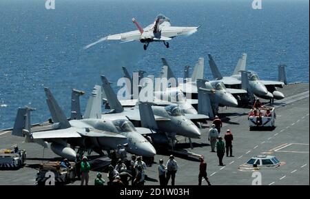 A U.S. Navy F/A-18F Super Hornet takes off from the flight deck of the Nimitz-class USS George Washington for joint military exercises between the U.S. and South Korea in South Korea's East Sea July 26, 2010. North Korea has declared a 'sacred war' against the United States and South Korea in retaliation for the allies' military drills that began on Sunday, accusing them of driving the Korean peninsula to the brink of explosion.  REUTERS/Lee Jin-man/Pool (SOUTH KOREA - Tags: POLITICS MILITARY)