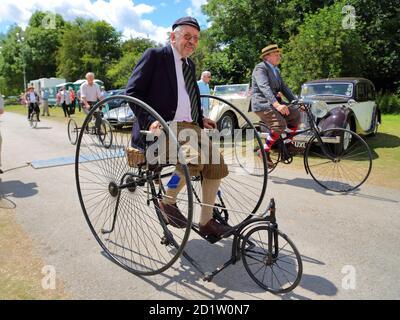 A man riding a vintage tricycle at the Traditional Boat Festival in Henley-on-Thames, Oxfordshire, UK Stock Photo