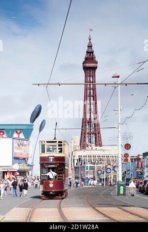 General view looking along the Promenade from the south, with a tram approaching and Blackpool Tower in the background, Blackpool, Lancashire, UK. Stock Photo