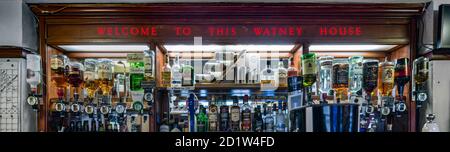Liquor bottles behind bar counter at The Queen Elizabeth, Merrow Street, Walworth, Southwark, London, UK. Stock Photo