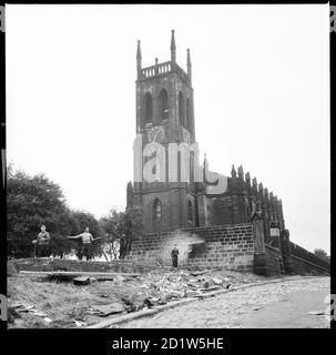 Three boys playing the derelict remains of a structure to the west of St Mary's Church, St Mary's Street, Quarry Hill, Leeds, UK. Stock Photo