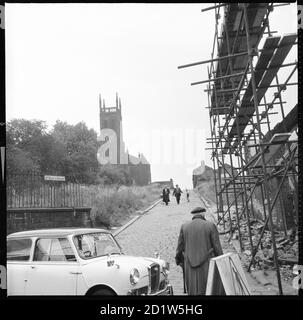 A view looking along St Mary's Street towards St Mary's Church with scaffolding around partially demolished buildings in the foreground, Quarry Hill, Leeds, UK. Stock Photo