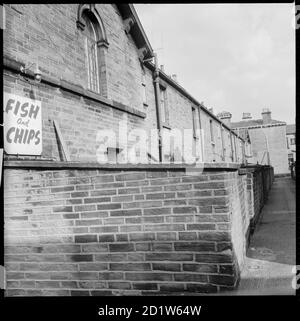 A view from Upper Mary Street looking east along the alleyway between Titus Street and Constance Street, Saltaire, Shipley, Bradford, West Yorkshire, UK. Stock Photo