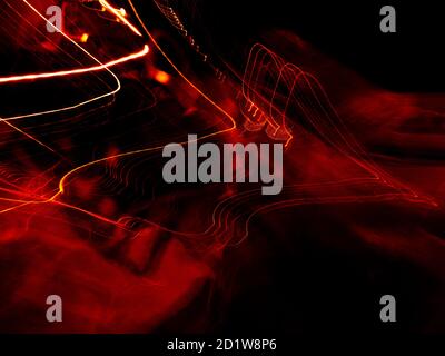 Burning red hot sparks fly from large fire in the night sky. Beautiful abstract background on the theme of fire, light and life. Burning embers glowin Stock Photo