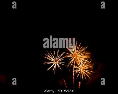 Burning sparklers on black background. Small fireworks giving off sparks of fire. Sparks explosion. During Armada exhibition in France Stock Photo