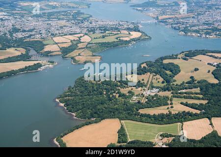 Antony Park, Cornwall. Landscape park and gardens designed by Humphry Repton at Antony Park, with the Royal Albert Bridge and Tamar Bridge in the distance to the north east, near Torpoint, Cornwall. Aerial view. Stock Photo