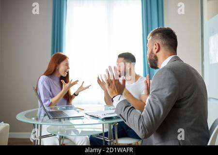even professional psychologist is powerless to solve family problems, young caucasian couple is arguing in the presence of psychologist, listening them, ready to help Stock Photo