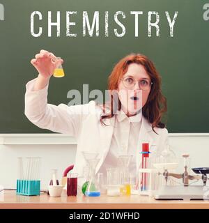 A chemistry teacher is conducting an experiment in test tubes with surprise on his face, copy space. Chemistry lessons at school, concept Stock Photo