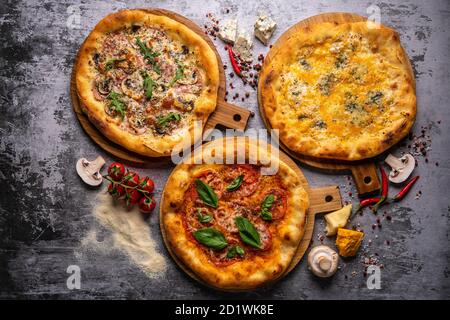 Pizza pattern. Three pieces set on grey concrete background. Top view, copyspace Stock Photo