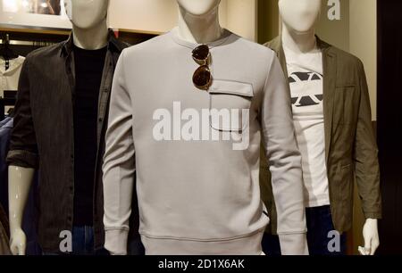 Closeup of three male mannequins wearing casual clothes in the male's department Stock Photo