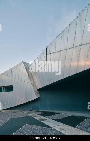 Imperial War Museum North, which represents a shattered globe, was the first building in the UK by Daniel Libeskind. Built on a bomb site, it was completed in 2002 in Salford Quays, Manchester, England, UK. Stock Photo