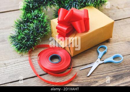 diy gift concept / Homemade wrapped christmas presents with tools and decorations on wooden , DIY hobby gift box wrapped brown paper collection in for Stock Photo
