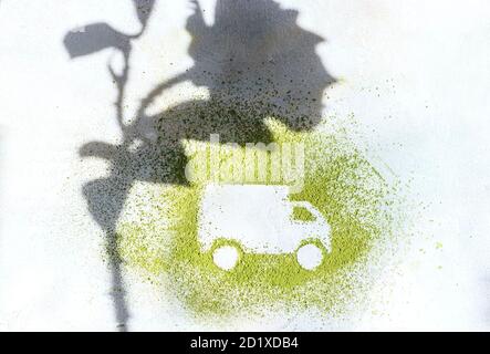 A car made of green powder and the shadow of plants on a light background. Online shopping. Flowers delivery concept. Stock Photo