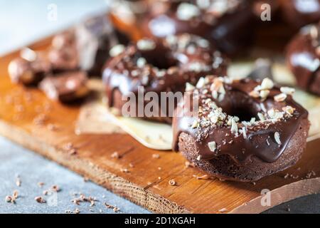 Chocolate donuts with chocolate glaze, nuts. National Donut Day. Homemade baking. Stock Photo