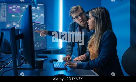Male and Female Programmers Talking about Work, Solving Problems Together, Using Computers. Software Development Code Writing Website Design Database Stock Photo
