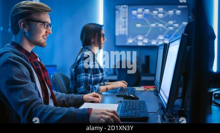 Male and Female Programmers Talking about Work, Solving Problems Together, Using Computers. Software Development Coding Web Design Database Stock Photo