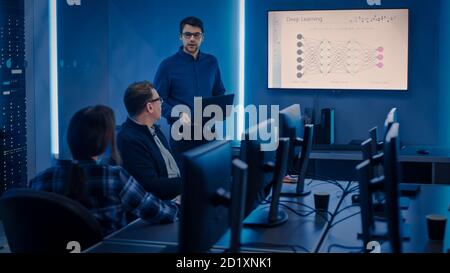 Team of Professional IT Developers Have a Meeting, Speaker Talks about New Blockchain Based Software Development Shown on TV. Concept: Software Stock Photo