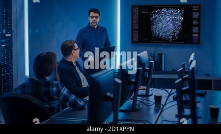 Team of Professional IT Developers Have a Meeting, Speaker Talks about New Blockchain Based Software Development Shown on TV. Concept: Software Stock Photo