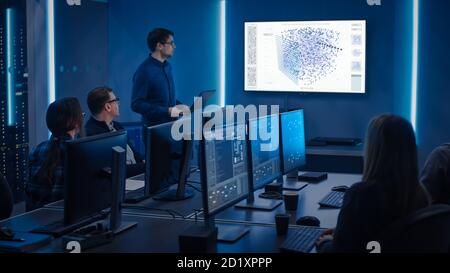 Team of Professional IT Developers Have a Meeting, Speaker Talks about New Blockchain Based Software Development Shown on TV. Concept: Software Stock Photo