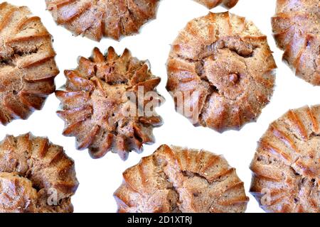 Heap of freshly baked brown eclairs isolated on a white background. Stock Photo