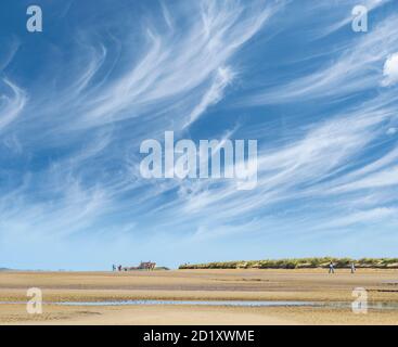 Cirrus clouds above a quiet Norfolk beach. Stock Photo