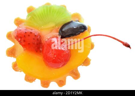 Fruit cake in a sand basket with cream decorated with cherry isolated on a white background. Stock Photo