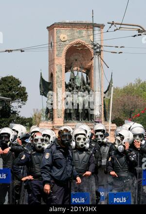 Riot police officers wearing gas masks wait in front of a monument of Ataturk, founder of modern Turkey, to stop May Day protesters from forcing their way into Taksim Square in Istanbul May 1, 2007. Turkish police detained 580 people in Istanbul on Tuesday in street battles with leftist demonstrators protesting on the May Day anniversary of a mass shooting 30 years ago. Police charged at hundreds of protesters, many from leftist organisations, kicking and clubbing them in the city's main Taksim Square and neighbouring streets. REUTERS/Fatih Saribas (TURKEY)