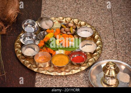 Symbolic serving of food at thread ceremony with toy children being served on banana leaves Stock Photo