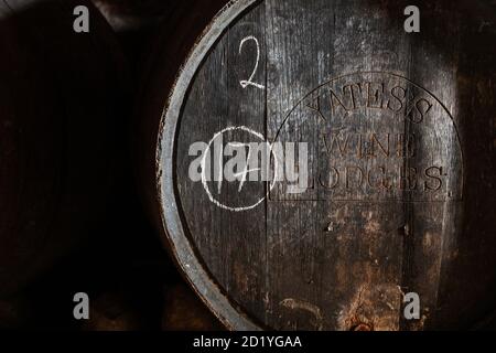 Old wine barrel for storing homemade Somerset cider in a dark shed Stock Photo