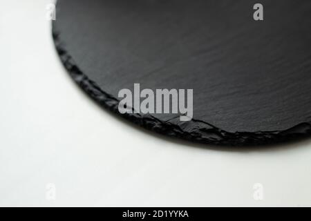 round black slate board on white background Stock Photo