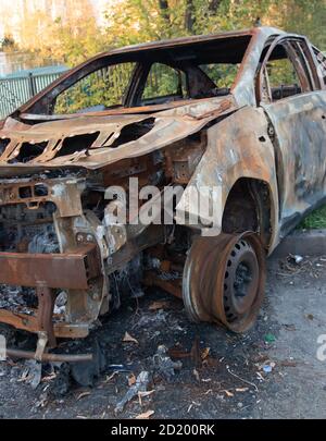 car burned down in a parking lot Stock Photo