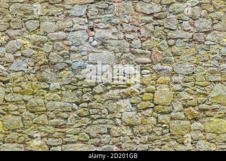 Seamless surface structure of brickwork. Ancient yellow bricks and stones wall background. Brick masonry horizontal technology architecture. Close up Stock Photo